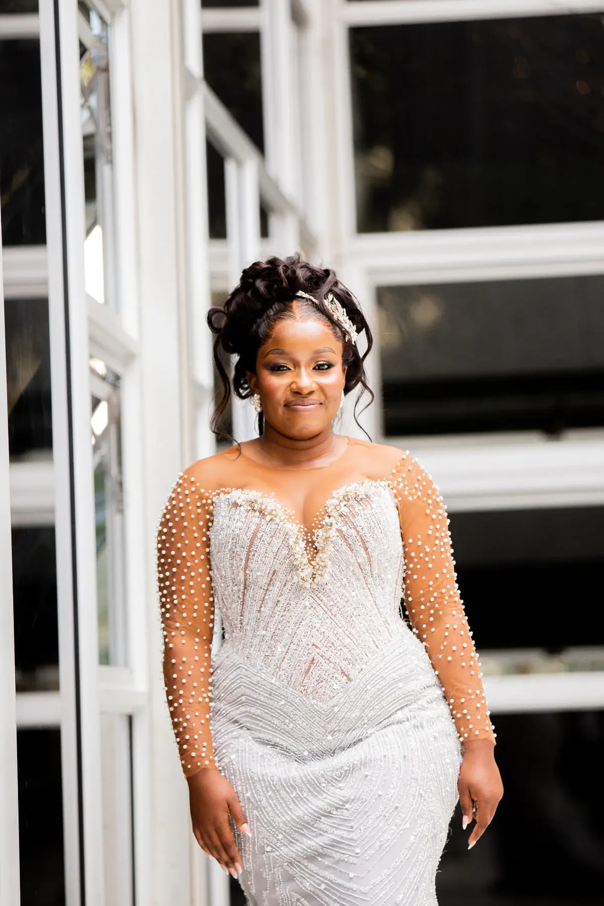 Nyasha smiling in her pearl-beaded wedding gown — founder's pre-Caronai experience, planned and coordinated by Tanaka